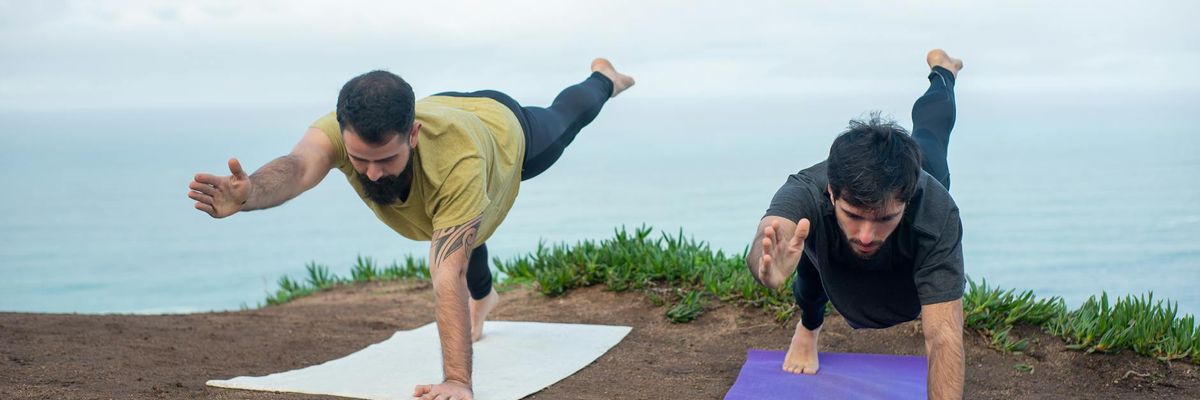 Group of men practicing stability exercises in a modern space